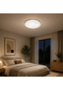 Wave LED ceiling light with wooden ring in a contemporary bedroom